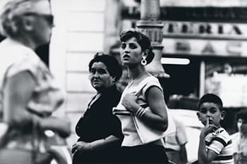 black and white photo of two ladies walking