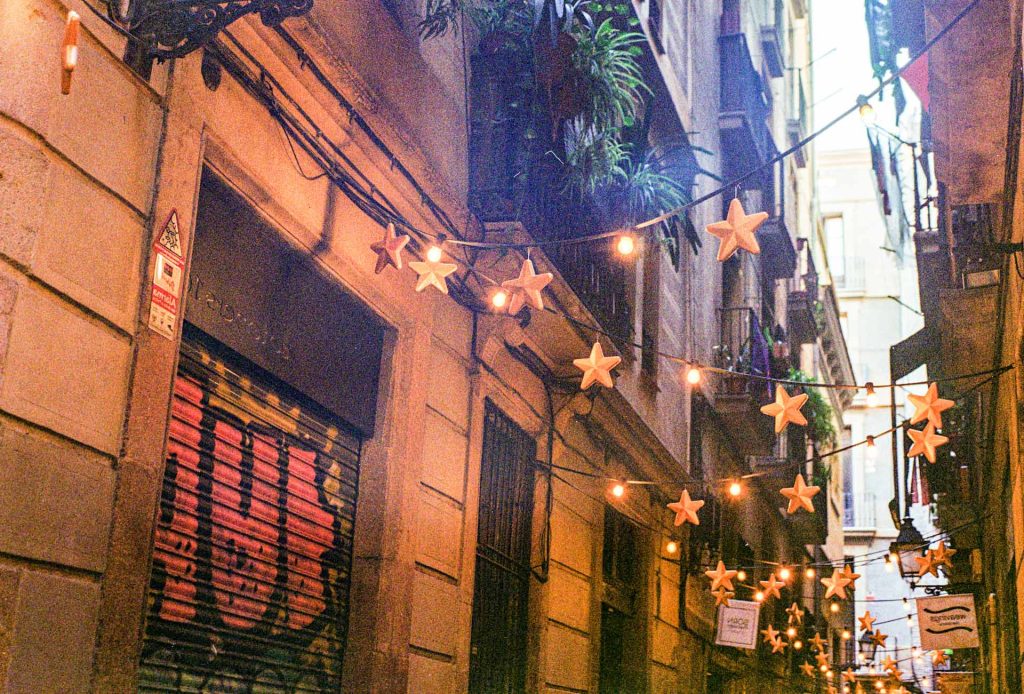 Charming street in the Old Town of Barcelona beautifully decorated by the locals with artisan decor.