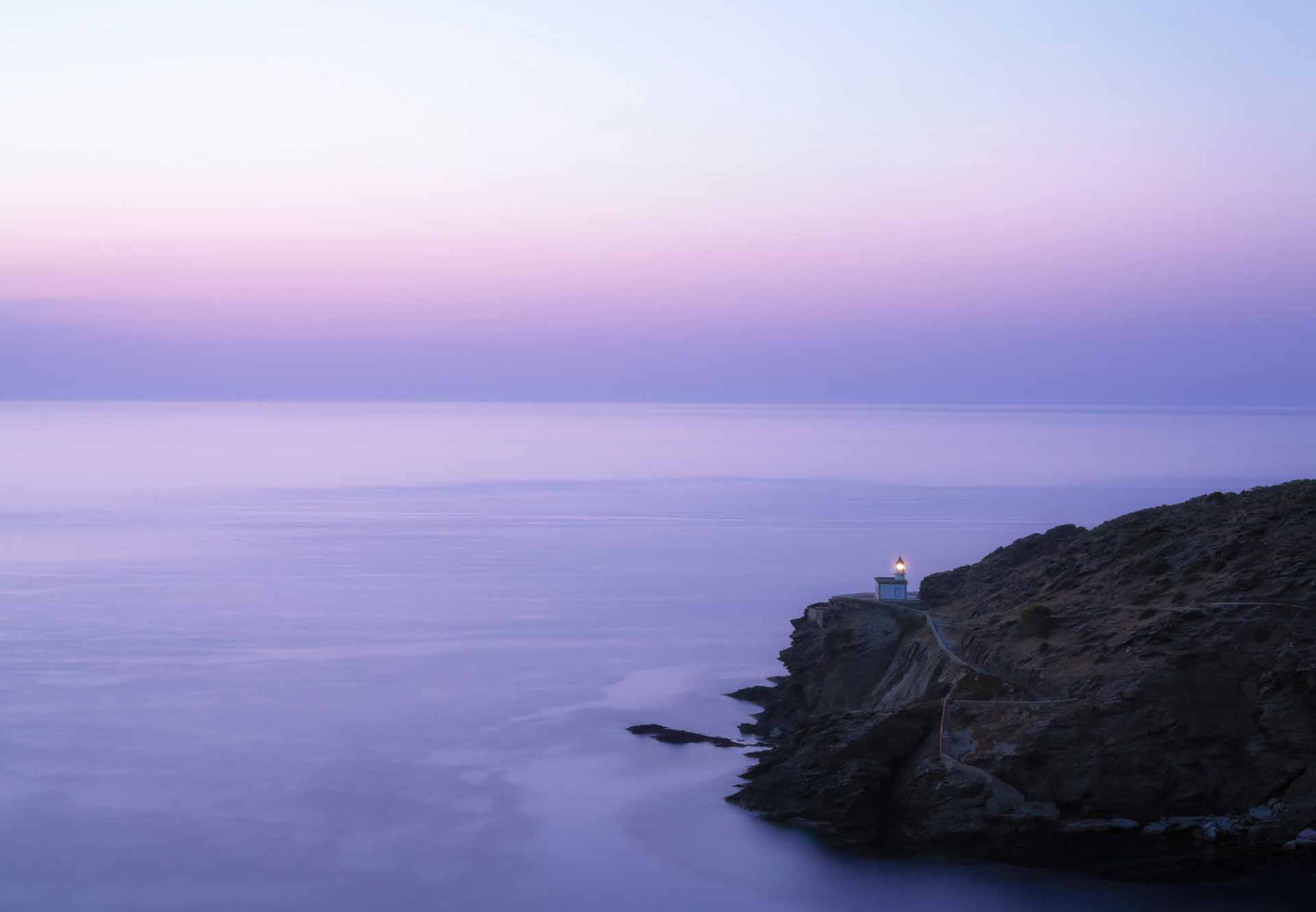 Costa Brava coastline with lighthouse at sunrise.