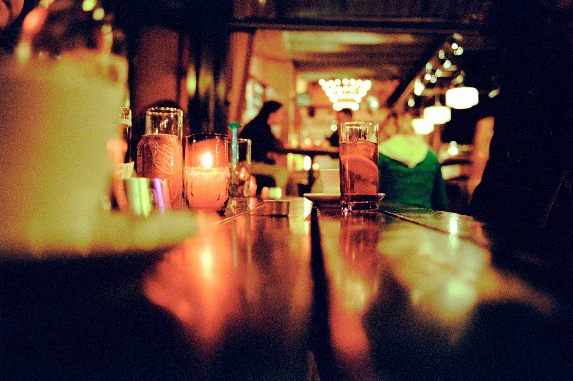 Spanish vintage looking classic vermouth bar with low light and wooden tables. 
