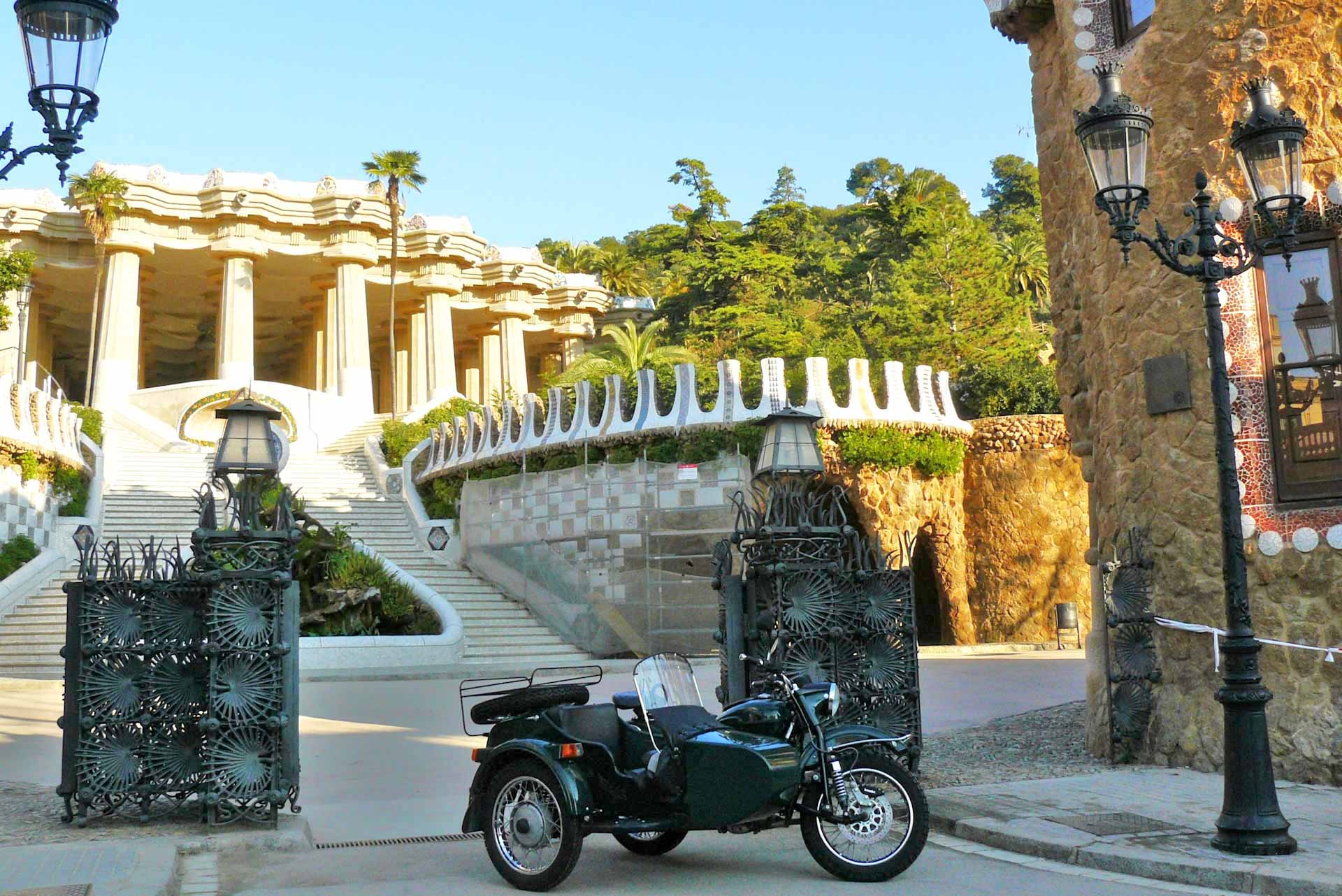 Main entrance to Park Guell with sidecar motorcycle of BrightSide Tours Barcelona.