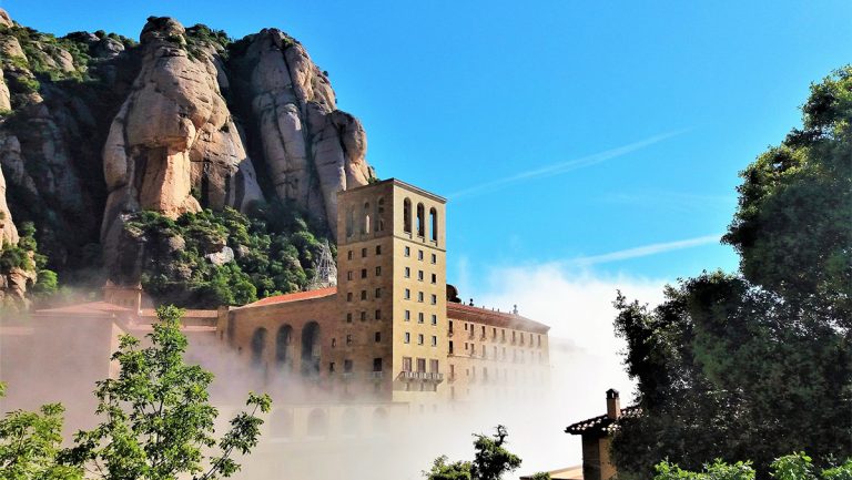 montserrat Monastery into the clouds during a day montserrat tour