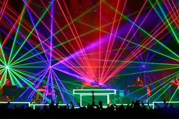 DJ performing on stage with many led lights