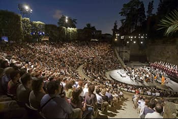 amphitheatre with crowd looking at a concert